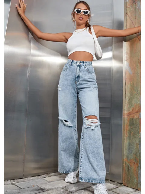 Blauwe losse gescheurde damesjeans hoge taille, rechte wijde pijpen